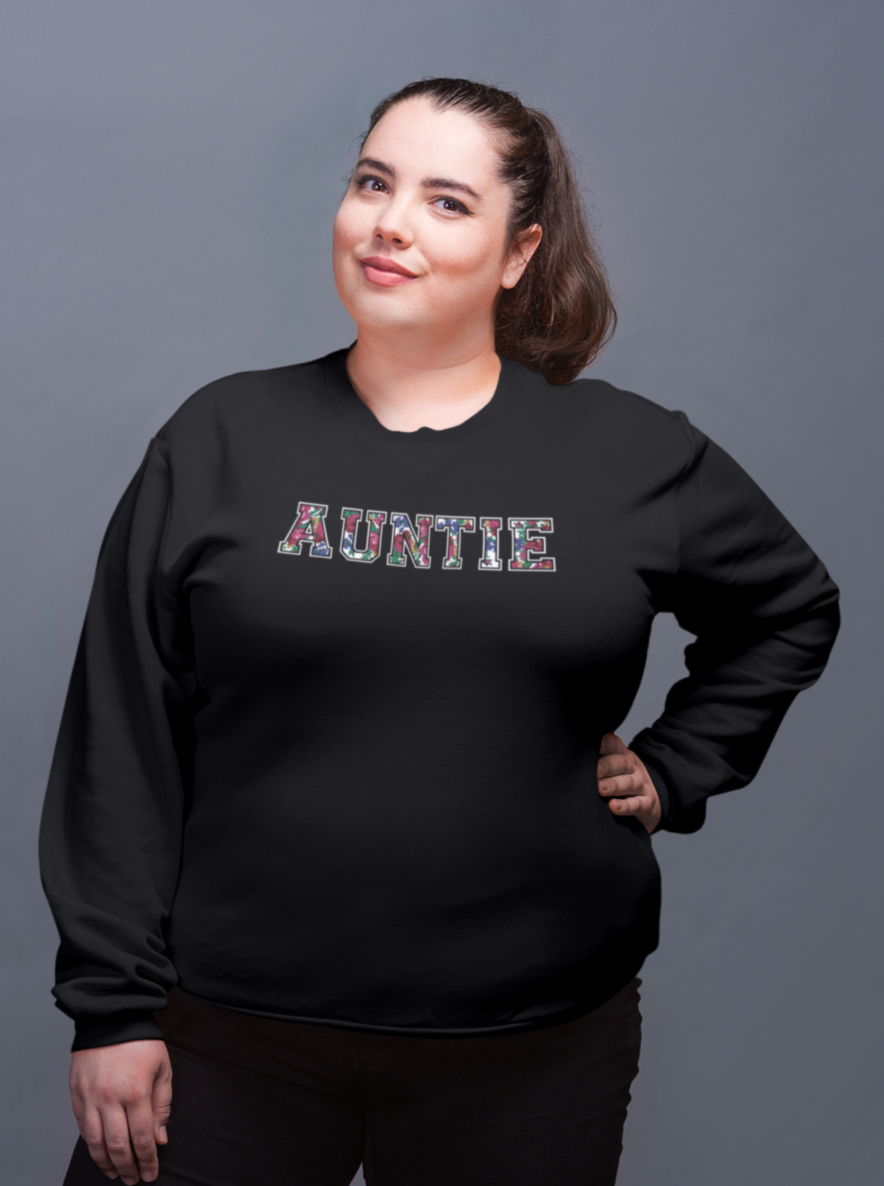 Black crewneck sweater with Auntie floral graphic on a posed model