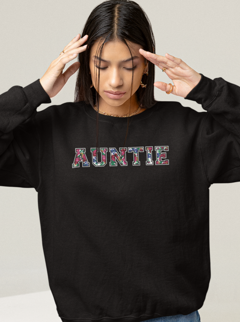 black crewneck sweater with Auntie floral graphic on a model